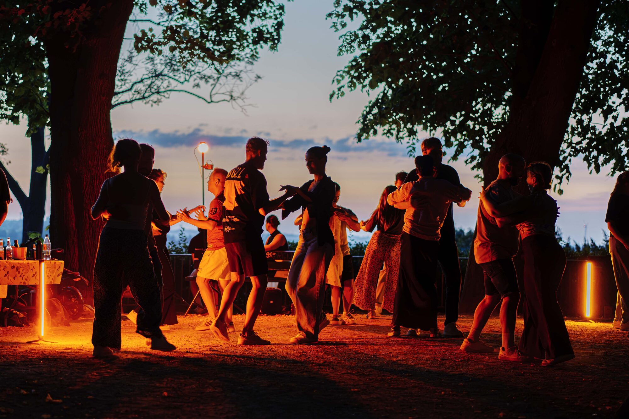 Dancers at golden hour under the trees